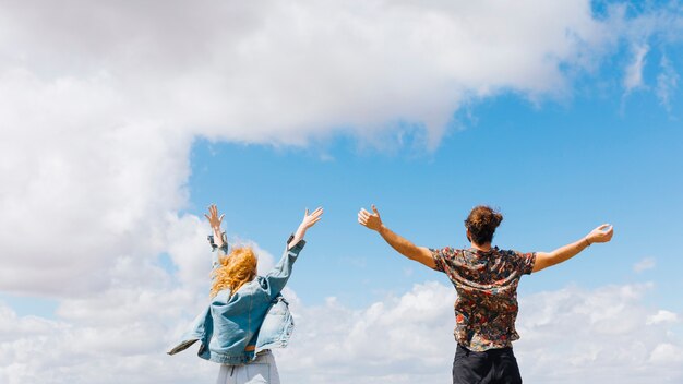 Excited and free couple with hands up