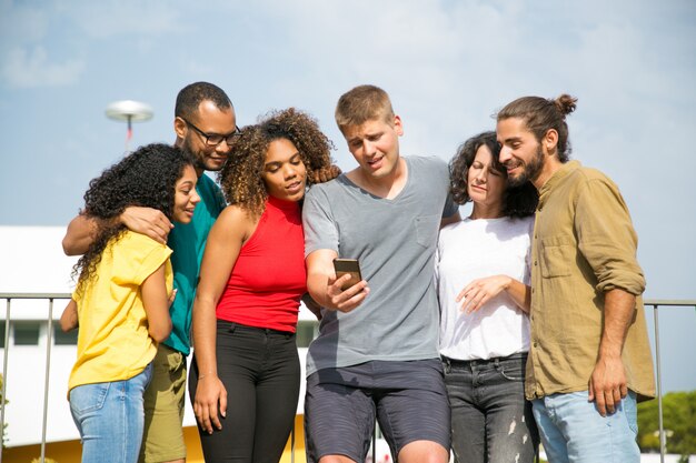 Excited friends watching adorable photos