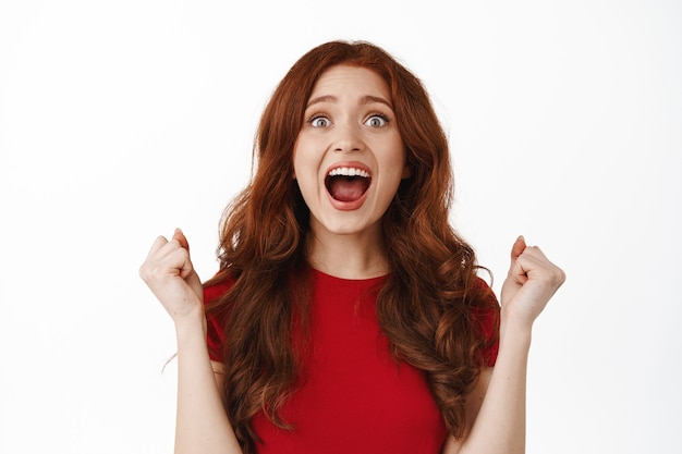 Free photo excited ginger woman on white