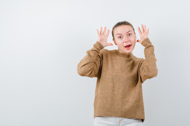 The excited girl is showing her emotions on white background