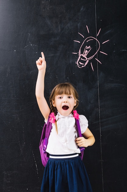 Excited girl pointing up