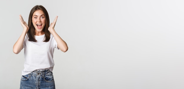 Excited happy young woman rejoicing from good news smiling cheerful