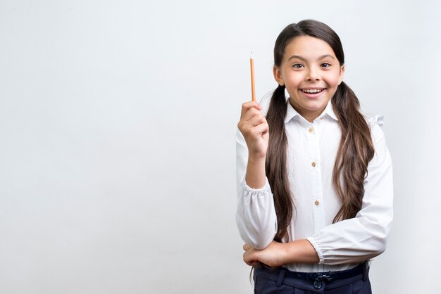 Excited Hispanic schoolgirl having idea