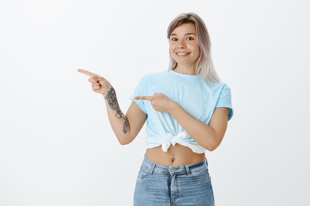 Excited joyful blonde girl posing in the studio