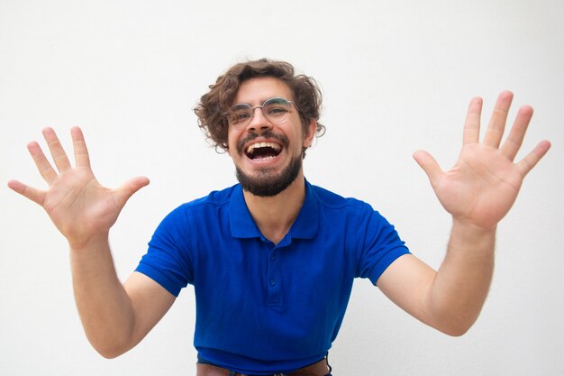 Excited joyful guy touching air