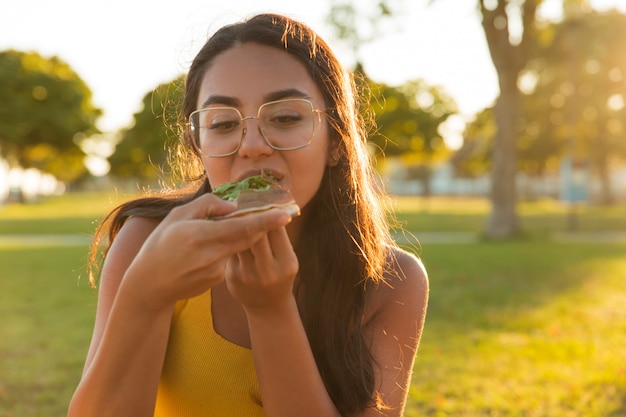 Excited Latin woman enjoying takeaway dinner