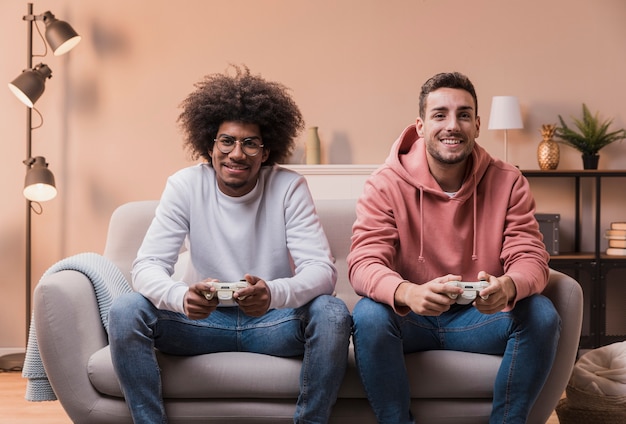 Excited male friends at home playing