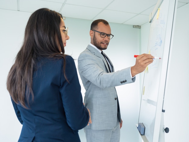 Excited male professional presenting analytics