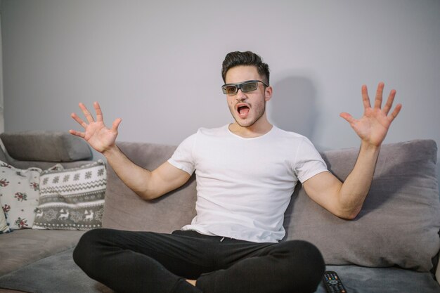 Excited man in 3D glasses watching TV