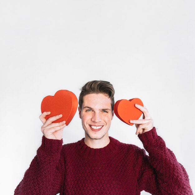 Excited man in love posing with hearts