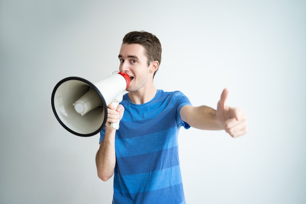 Excited man speaking into megaphone and pointing at you