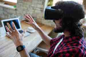 Free photo excited man using virtual reality headset