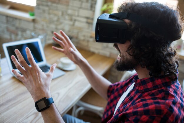 Excited man using virtual reality headset