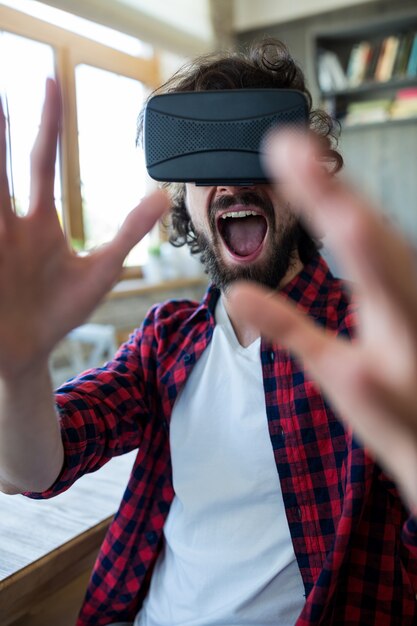 Excited man using virtual reality headset