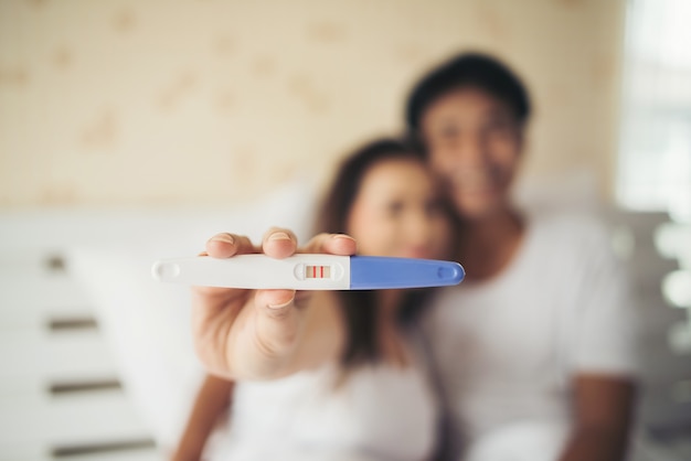 Free photo excited new parent hand show pregnancy test