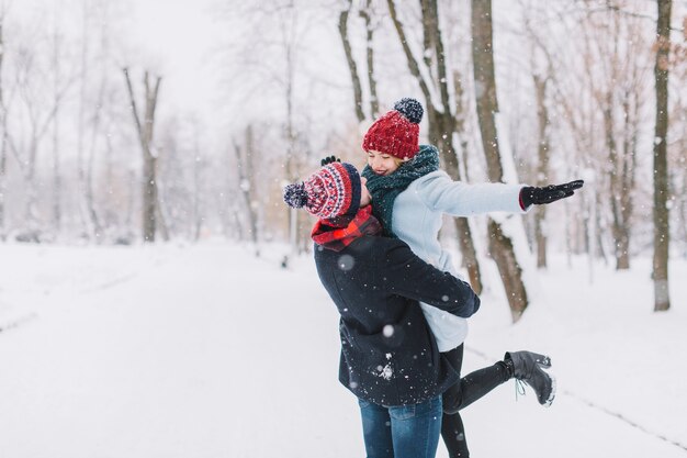 Excited romantic couple enjoying winter