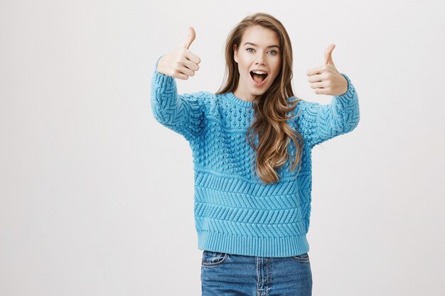 Excited satisfied woman thumb-up in approval