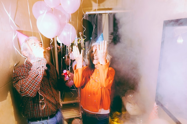 Excited senior couple enjoying the birthday party