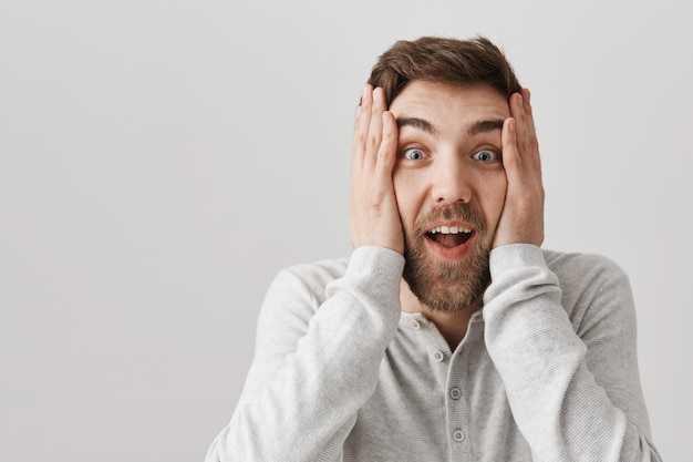 Excited smiling man react to amazing news