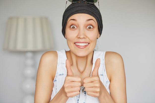 Excited student girl showing thumbs up