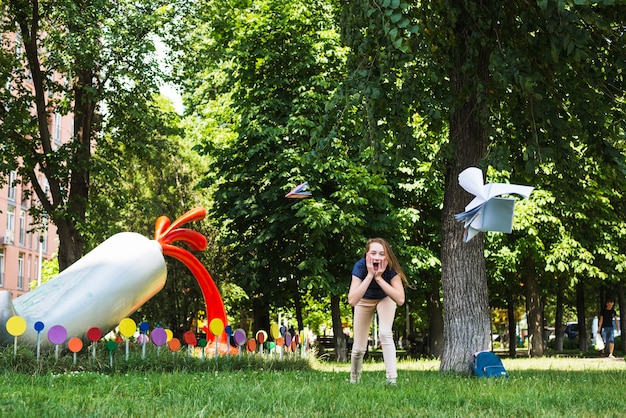 Excited student watching textbooks flying in air