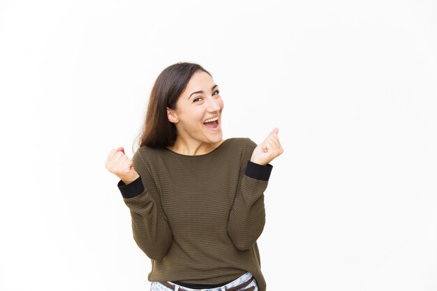 Excited surprised beautiful Latin woman rejoicing at good news