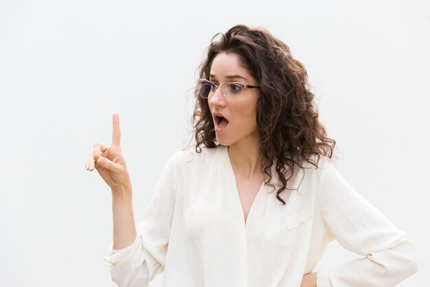 Excited surprised woman in glasses with open mouth