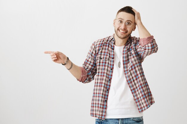 Excited and surprised young guy posing