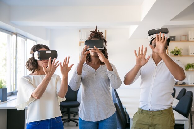 Excited team of three playing virtual game