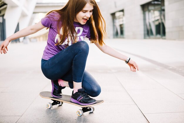 Excited teenager on skateboard