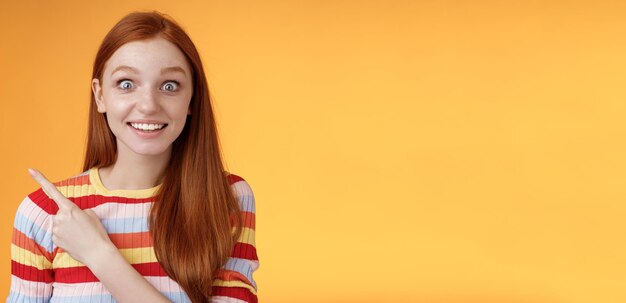 Excited thrilled goodlooking young silly redhead girl surprised pop eyes camera gasping impressed