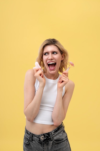 Excited woman holding beauty utensils