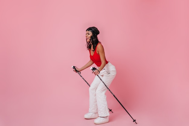 Excited woman holding ski poles