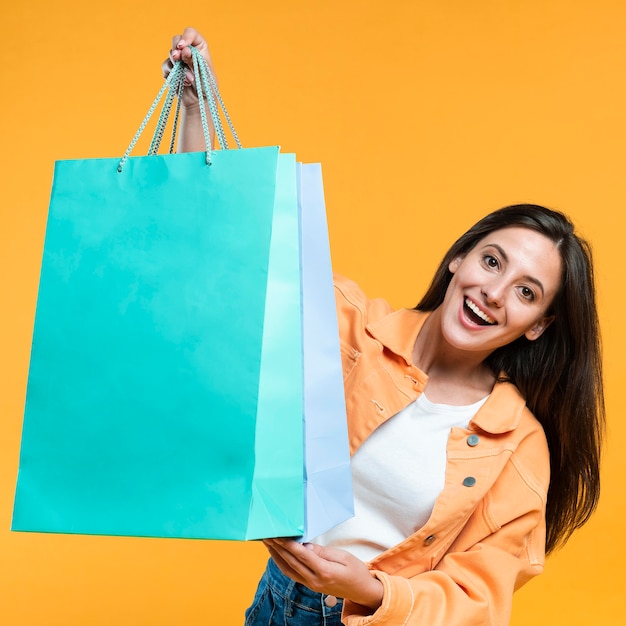 Excited woman holding up a lot of shopping bags