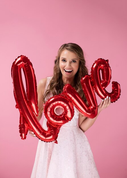 Excited woman holding word love