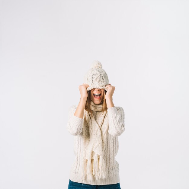 Excited woman pulling hat