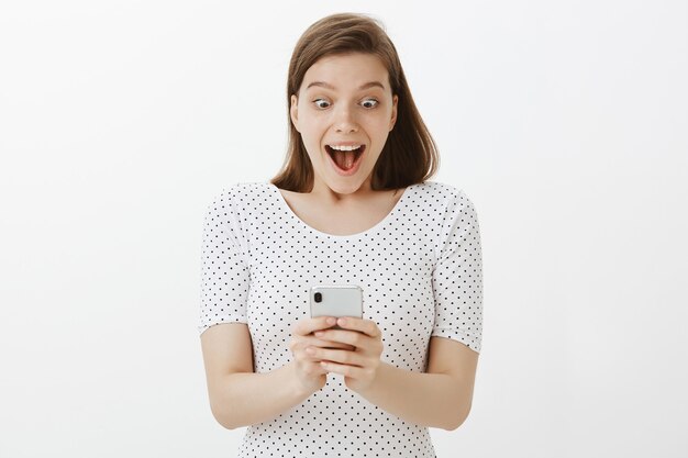 Excited woman receive positive answer on mobile phone