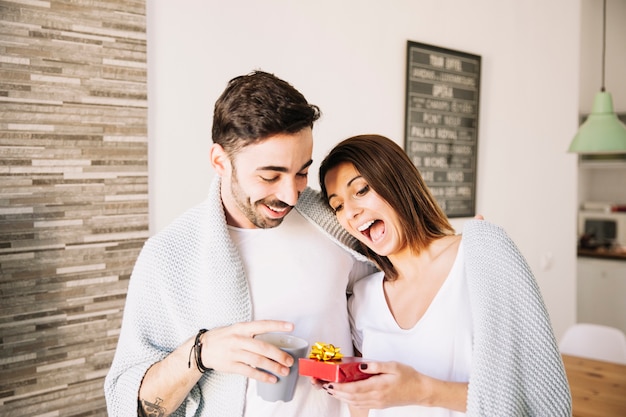 Free photo excited woman receiving gift from man