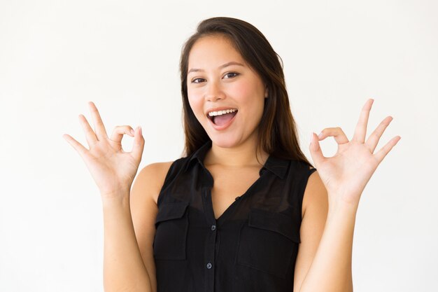 Excited woman showing ok sign