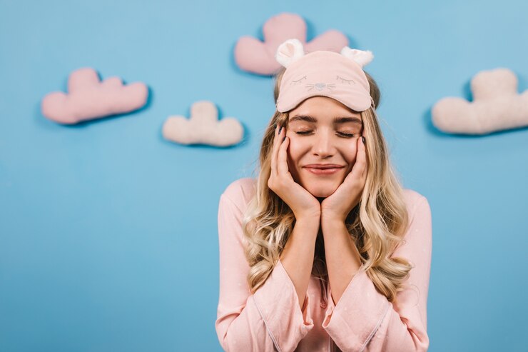 Free Photo excited woman in sleep mask smiling with eyes closed