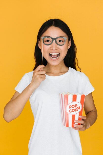 Excited woman trying on fake glasses