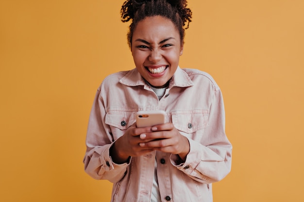 Excited woman using smartphone