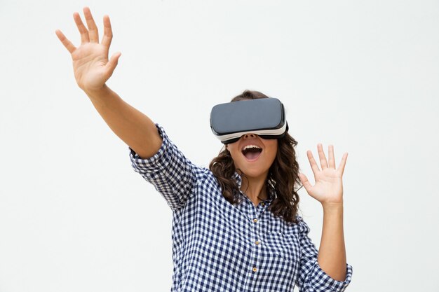 Excited woman using VR headset