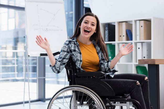 Excited woman in wheelchair indoors