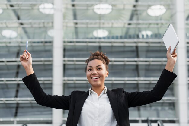 Excited woman with arms up