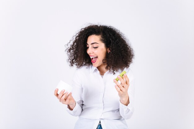 Excited woman with cream jar