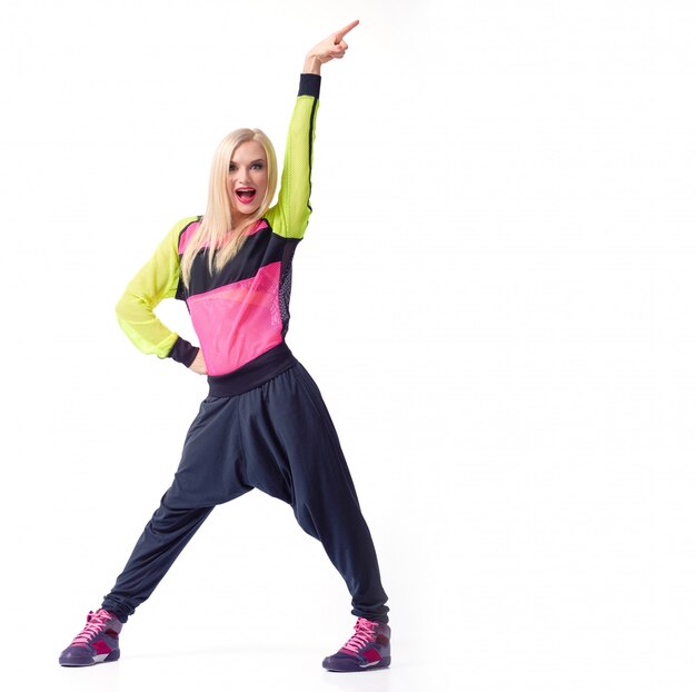 excited young active female posing with her arm up in the air wearing sports outfit copyspace isolated