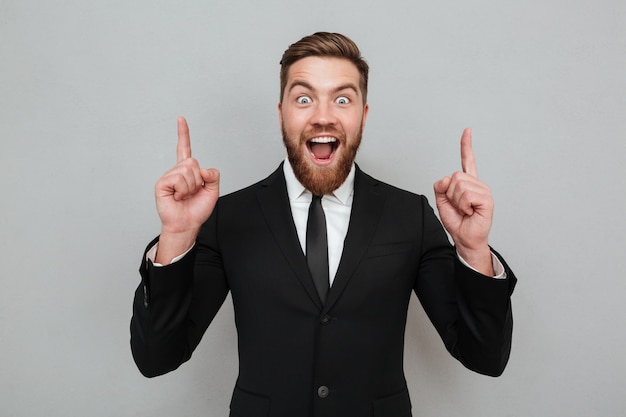 Excited young bearded businessman having an idea