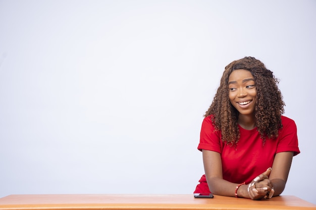 Excited young black lady gazes at the space to her side, advertising concept.