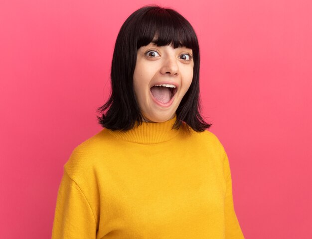 Excited young brunette caucasian girl stands